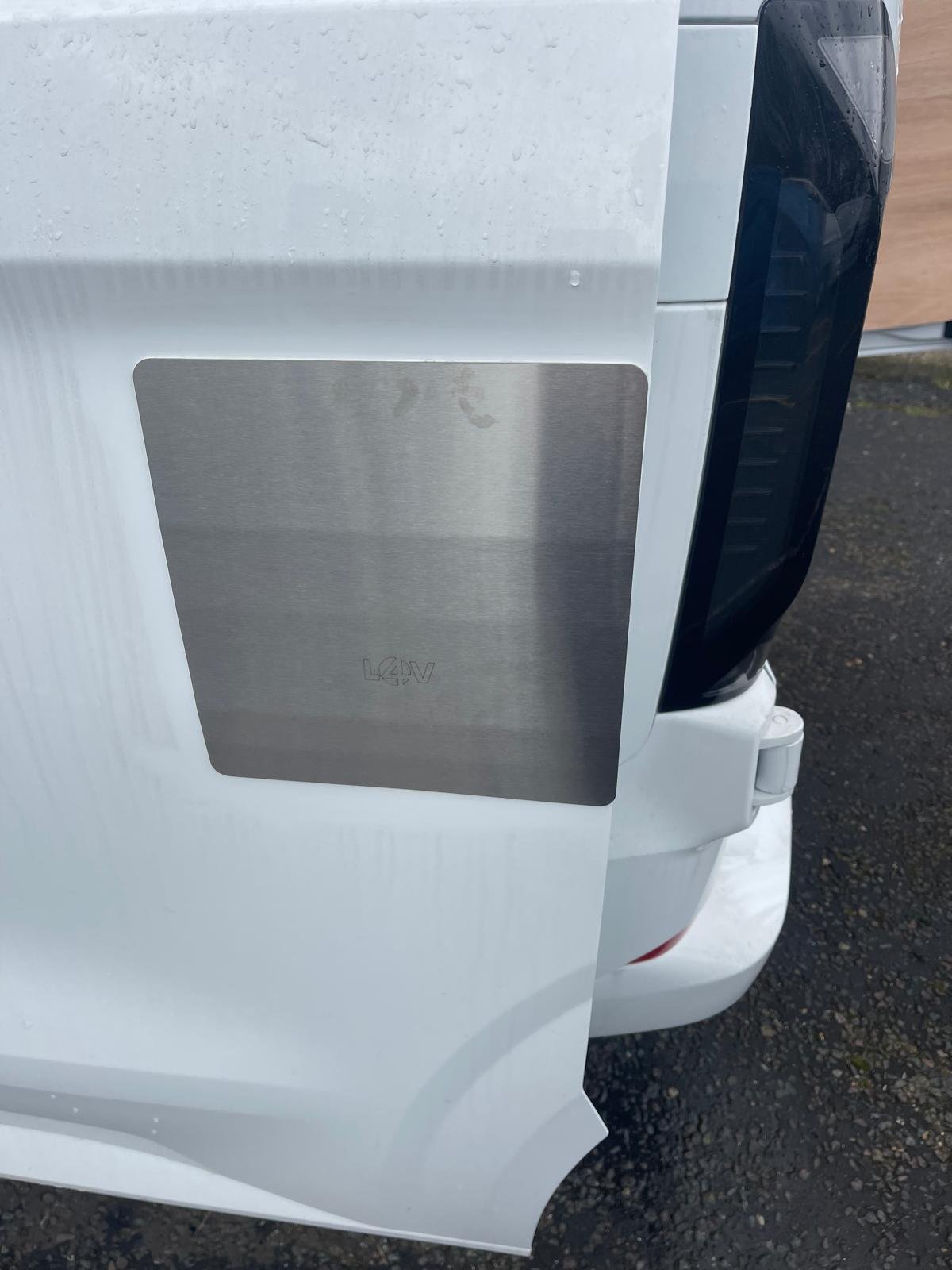 Colour-matched external security plate fitted to a van rear door